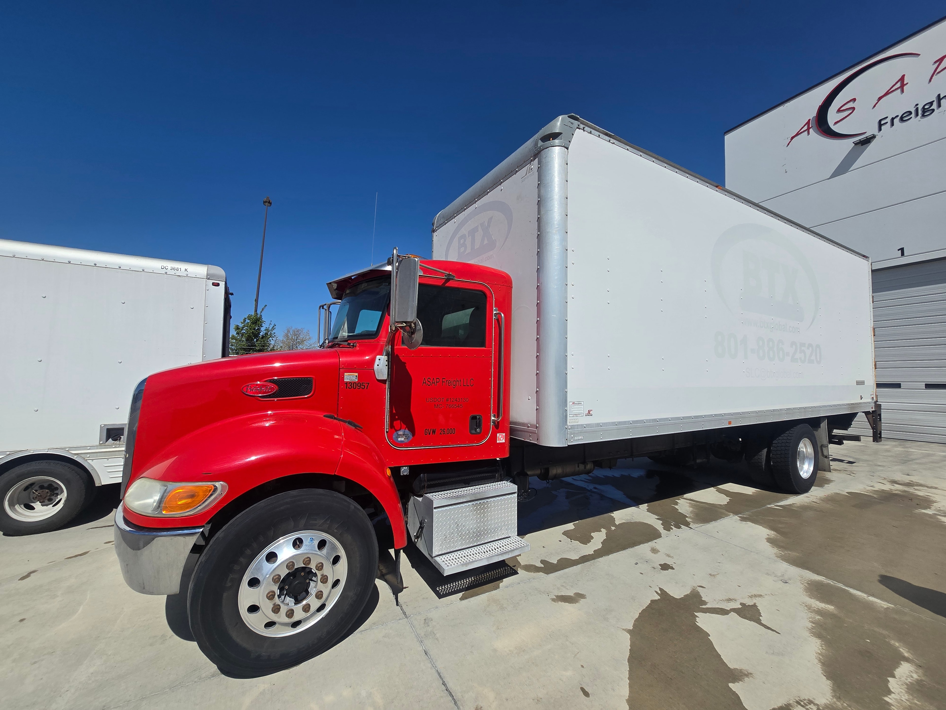 BTX Global Logistics Peterbilt box truck — driver-side profile after vinyl decal removal