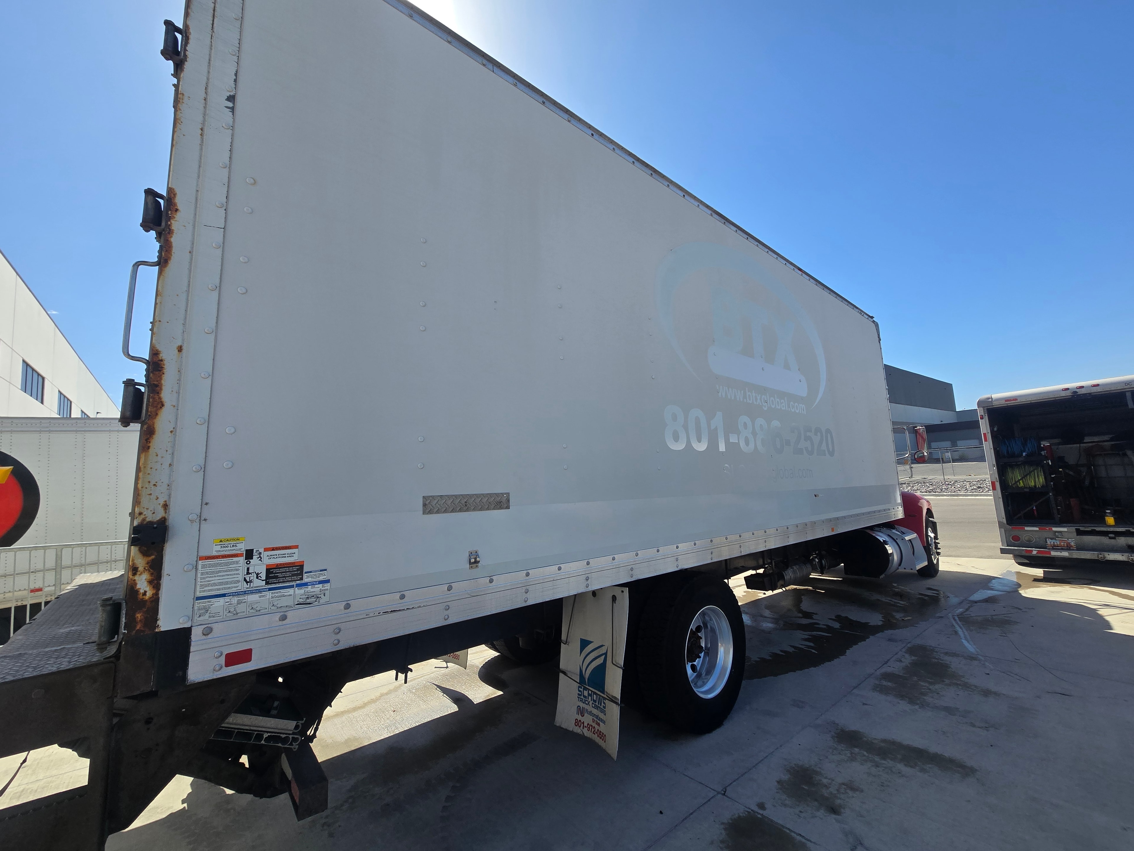 BTX Global Logistics box truck — rear passenger-side panel after decal removal and pressure washing