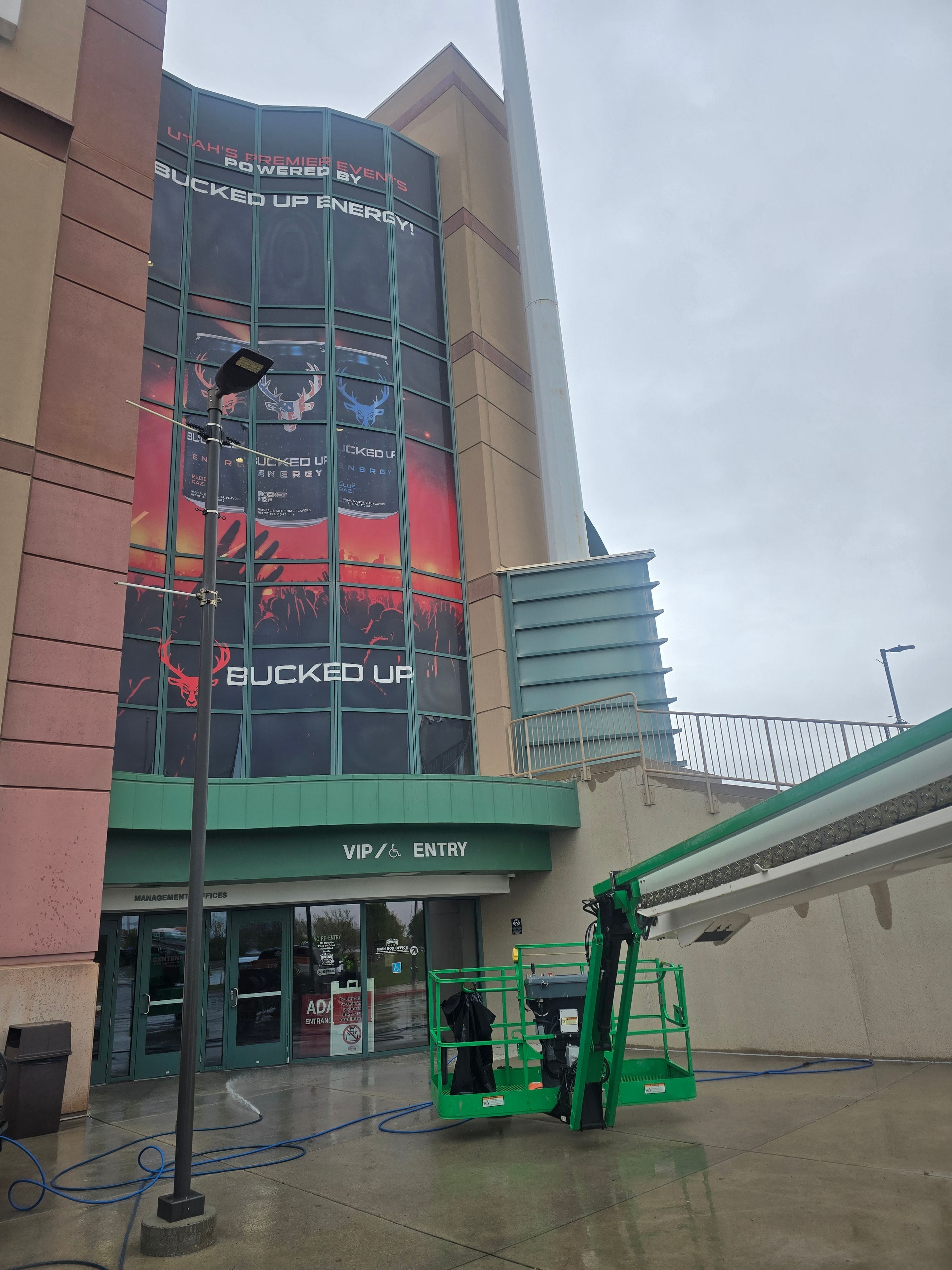 Angled view of Bucked Up arena window wrap before pressure washing — Maverick Center, Utah