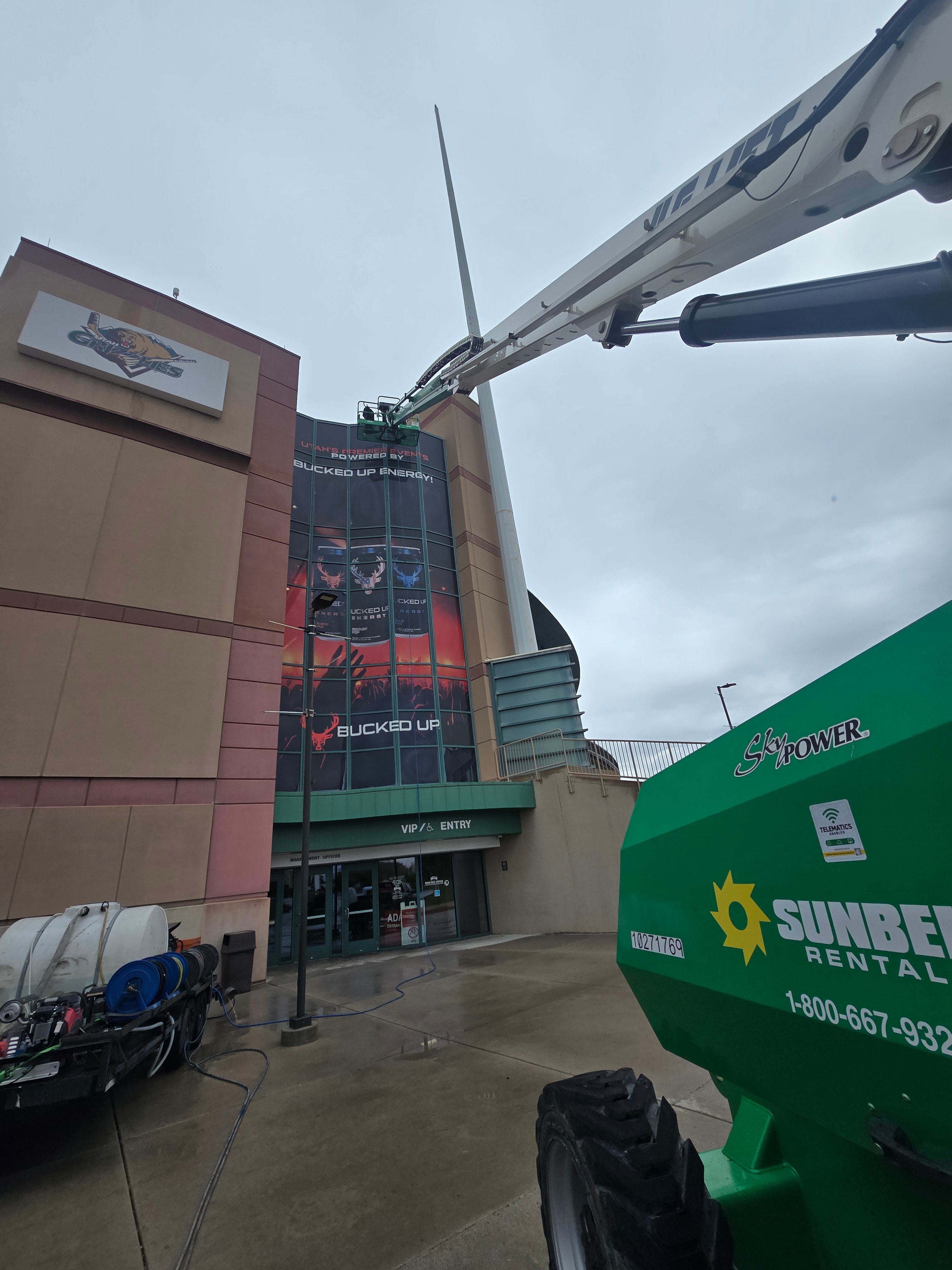 Side view of Bucked Up window wrap at Maverick Center before restoration — Utah