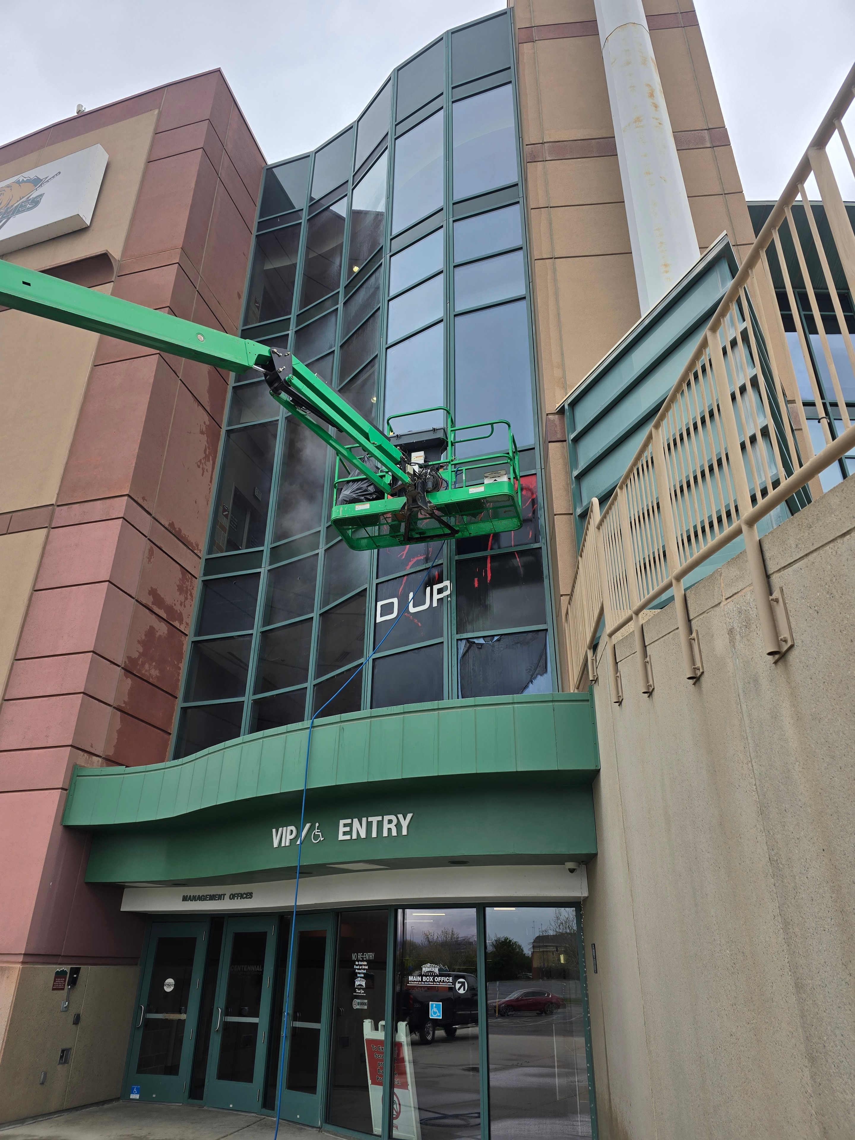 Closeup of boom lift basket at Maverick Center arena during Bucked Up wrap cleaning — Utah