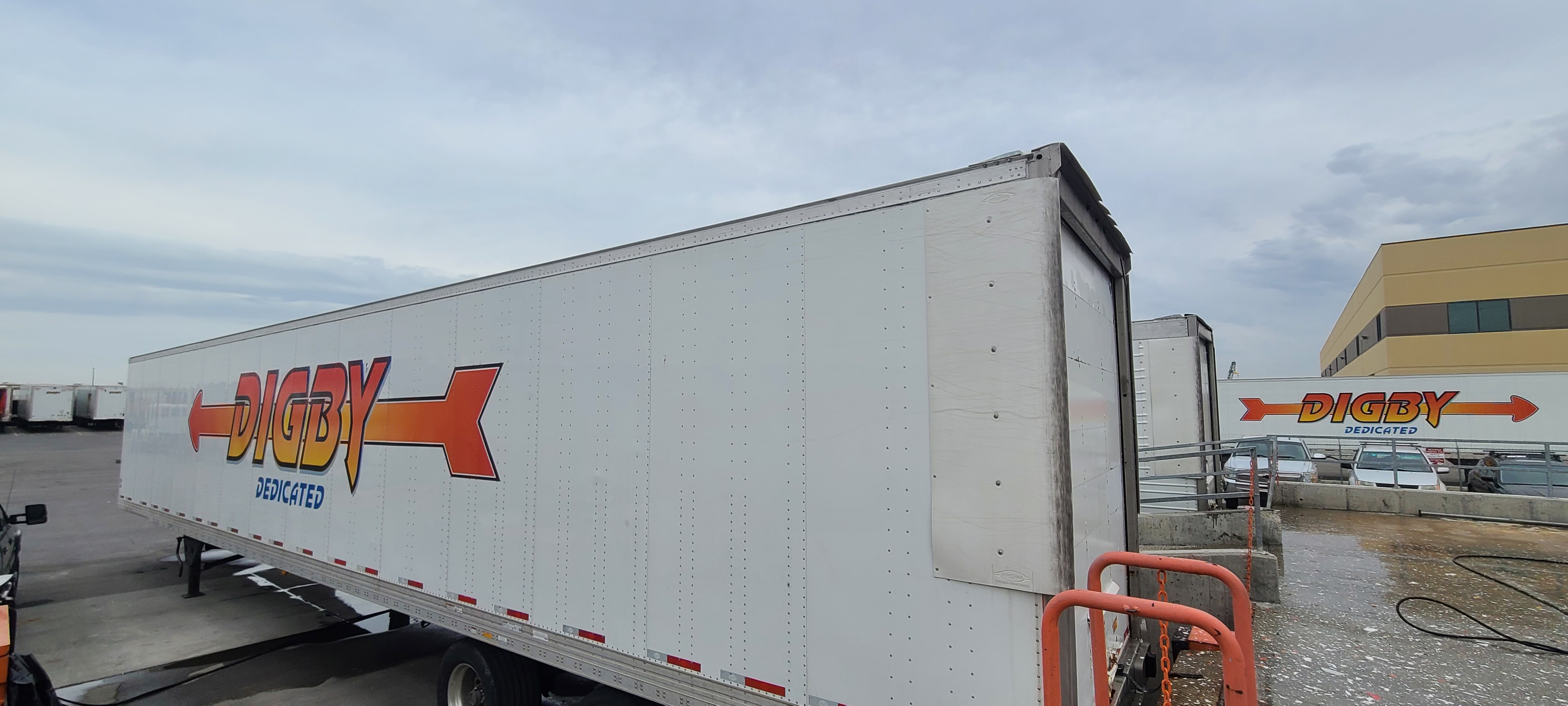 Digby Dedicated 53ft trailer at loading dock — side and rear panel branding before de-identification