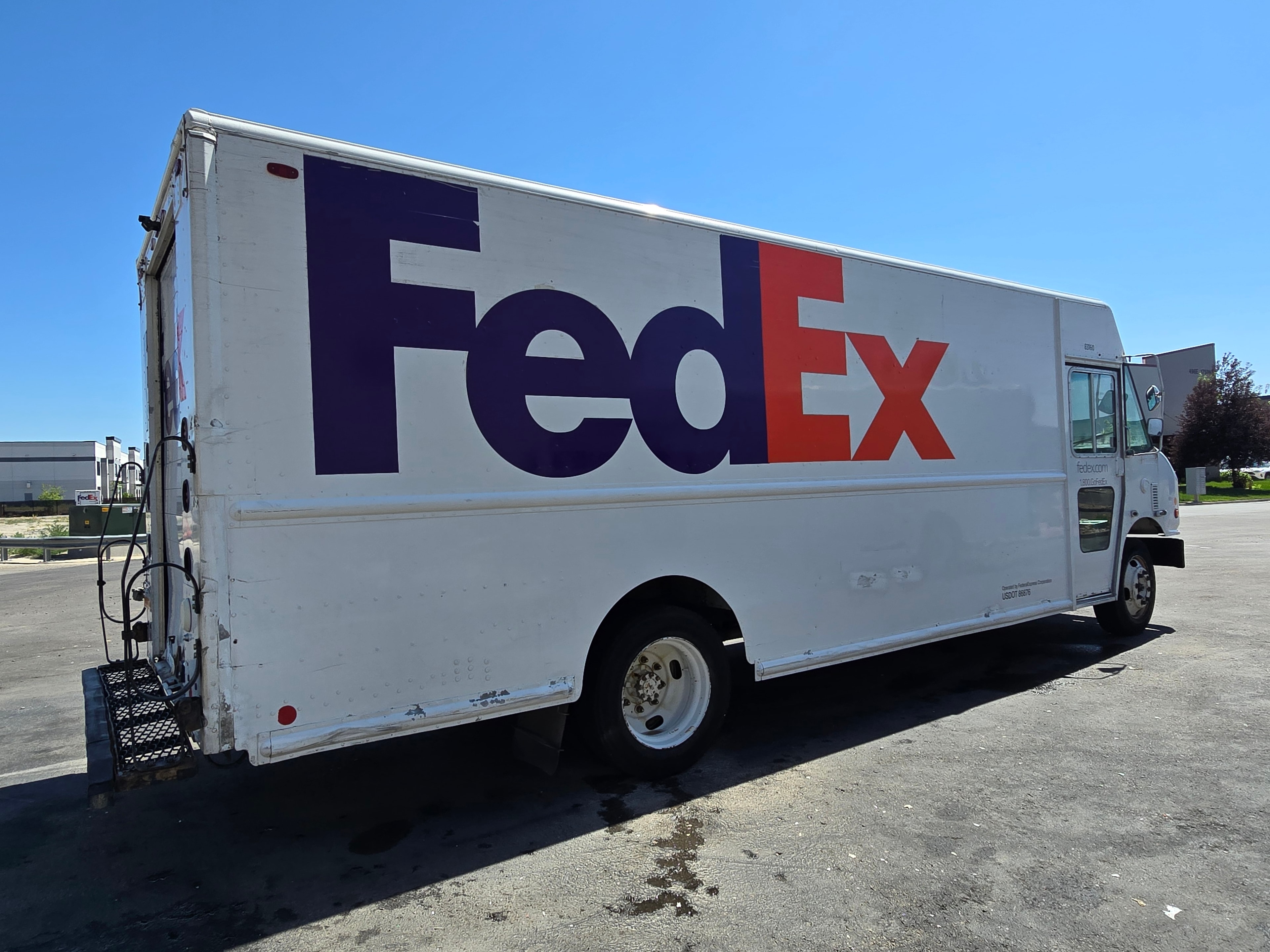 FedEx step van side profile after de-identification — clean white panel, decals removed, Utah fleet rebranding project
