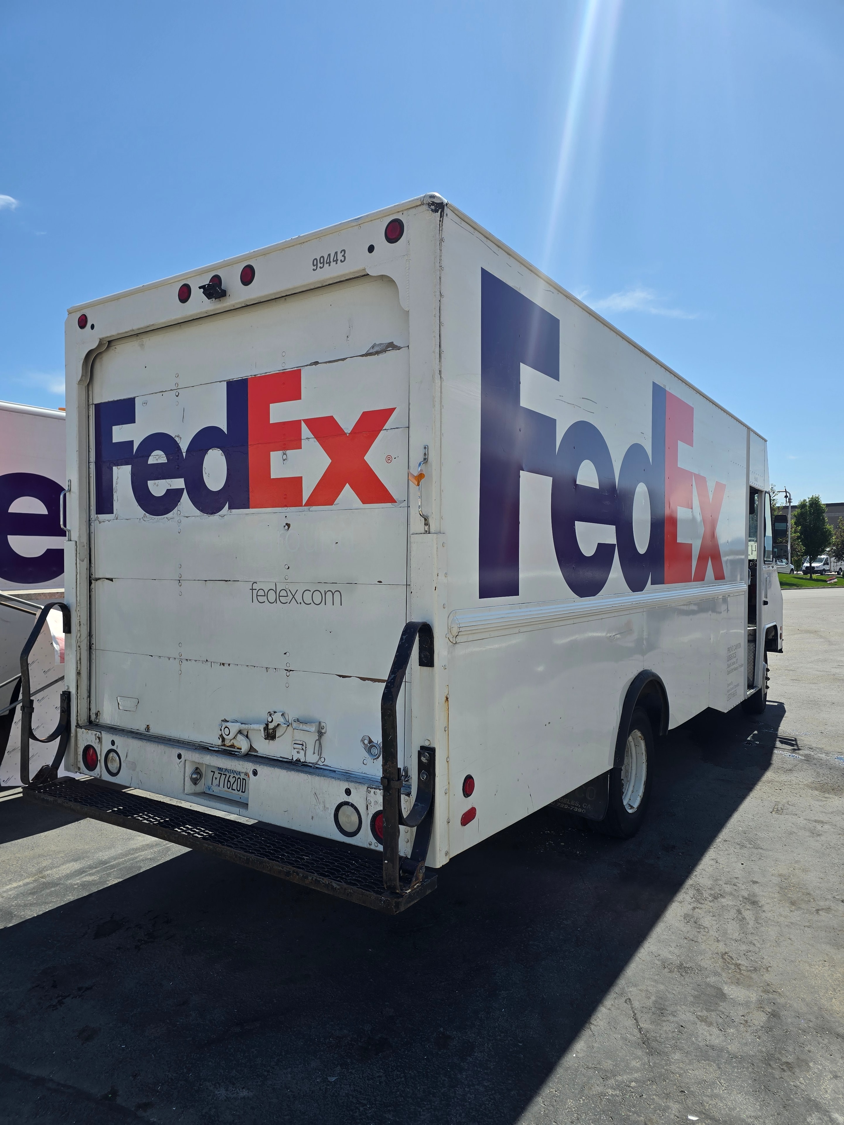 FedEx step van rear angle after decal removal — rear doors and side panel clean after Utah fleet rebranding