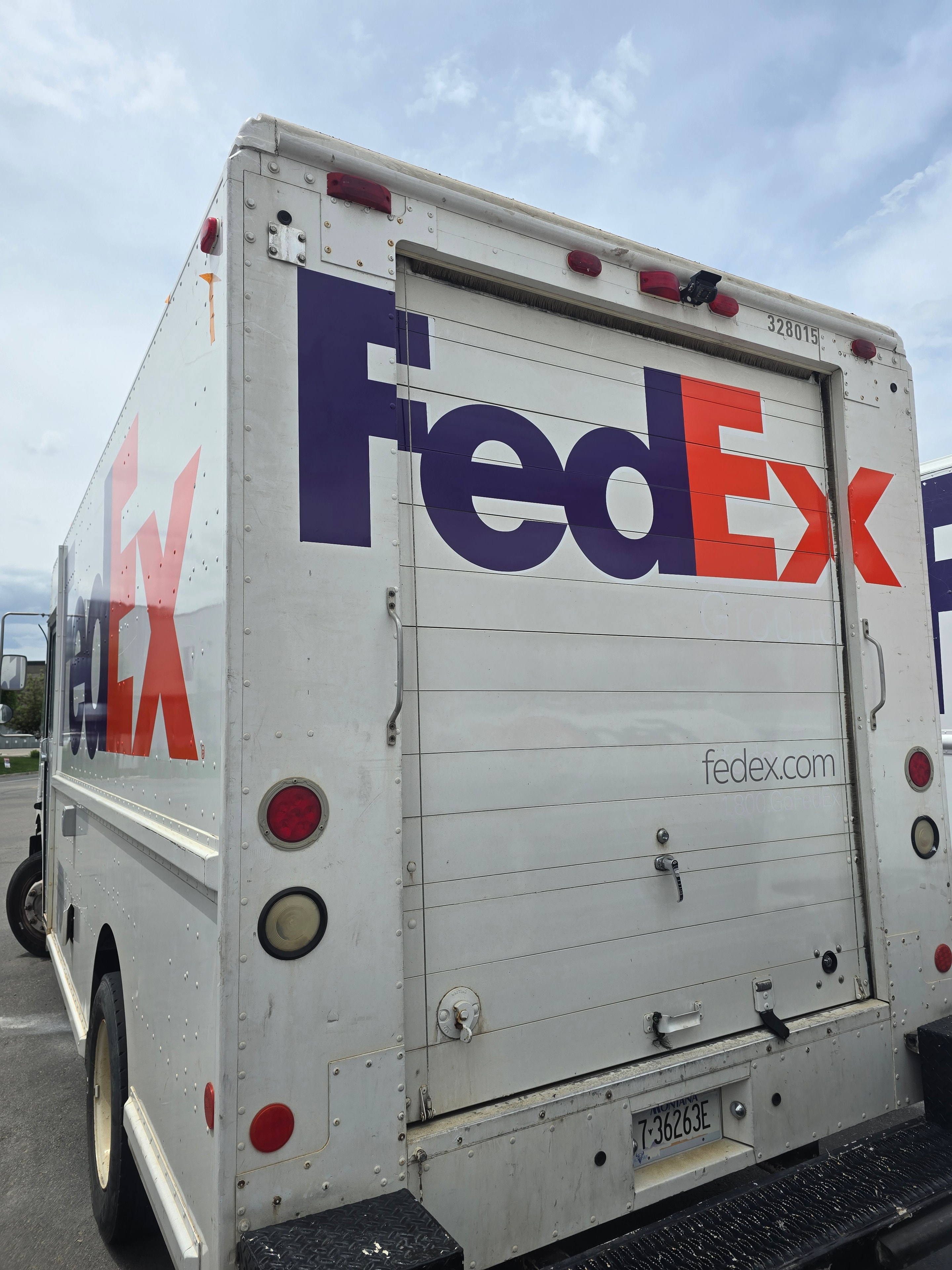 FedEx step van rear doors after decal removal — rear door graphics removed, clean surface after Utah fleet rebranding