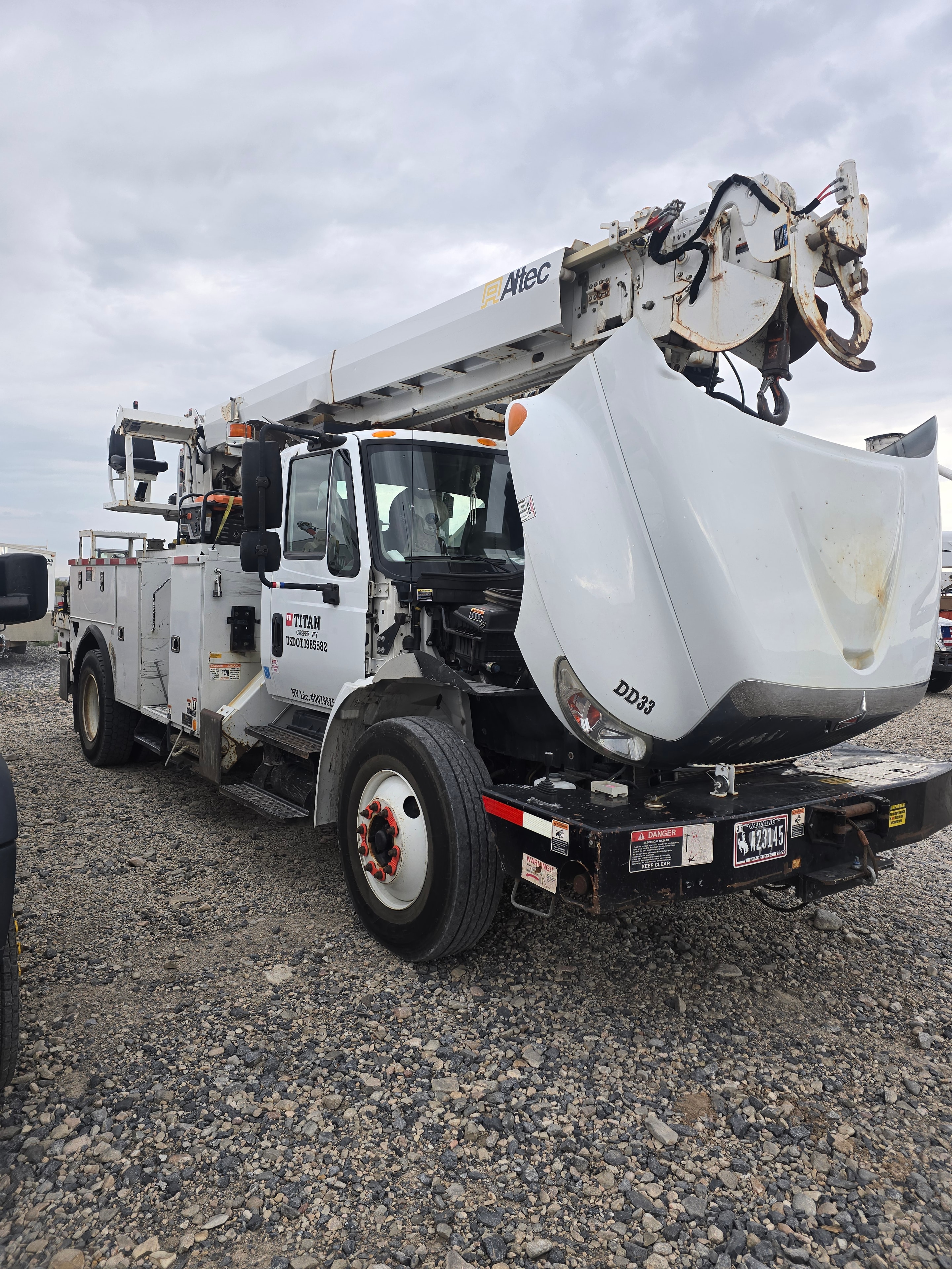 Titan Freightliner digger derrick DD33 before fleet washing — road grime and equipment residue