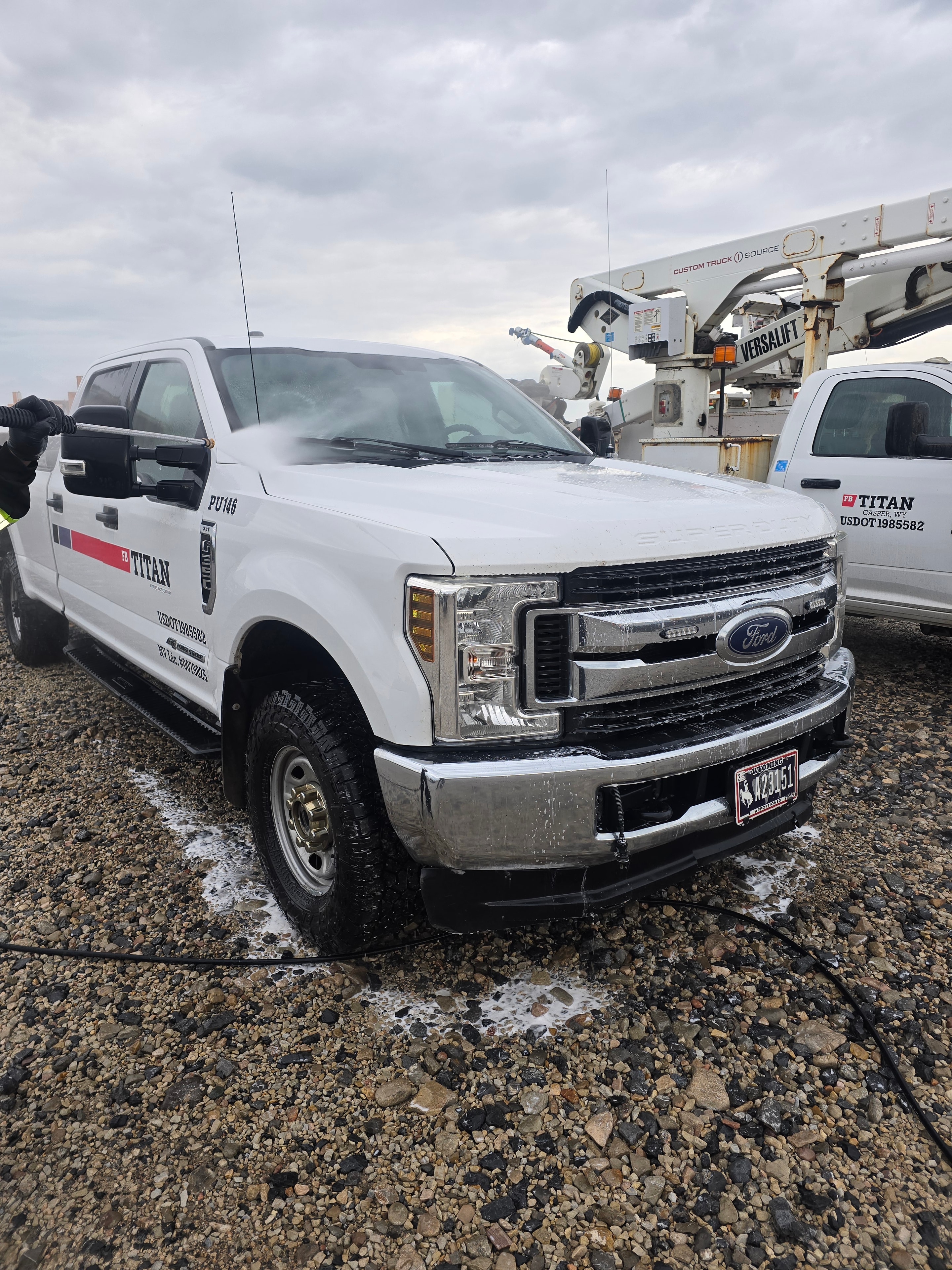 High-pressure rinse on Titan pickup truck fleet washing